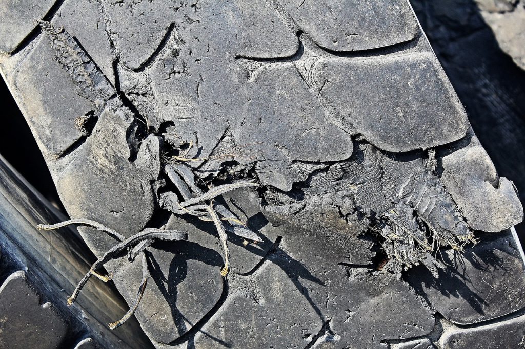 A close up image of a damaged car tyre
