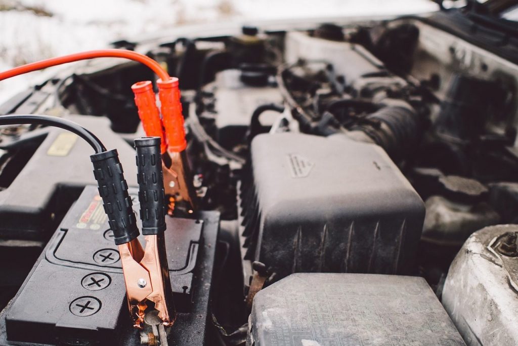 image of jumper cables on a car battery