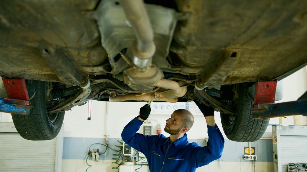 image of a man working on a car